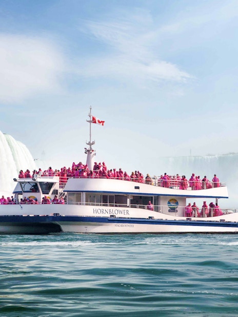 Hornblower Cruise near Niagara Falls with passengers in pink raincoats.