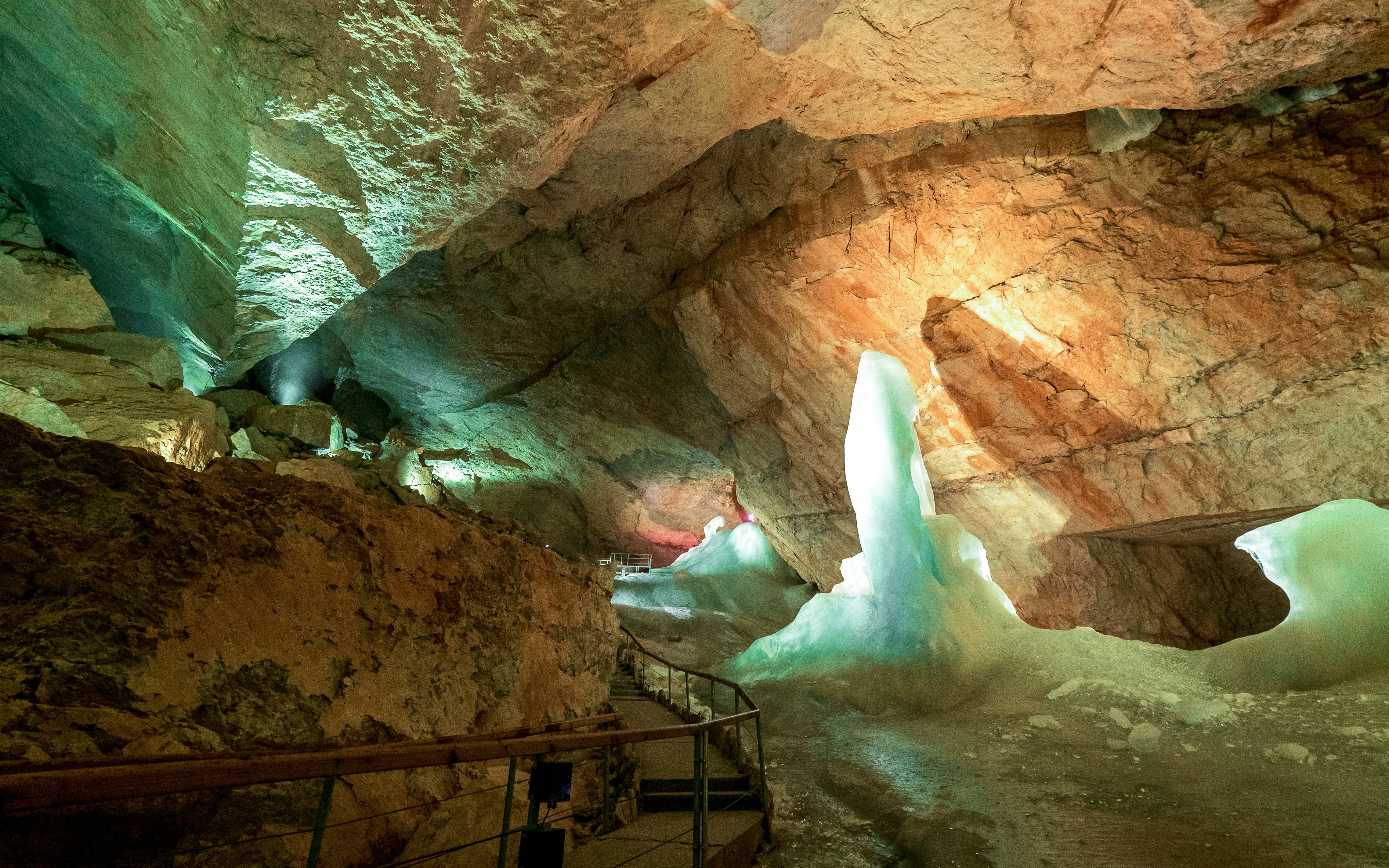 Dachstein Ice Caves Austria with illuminated ice formations and rocky cavern walls.