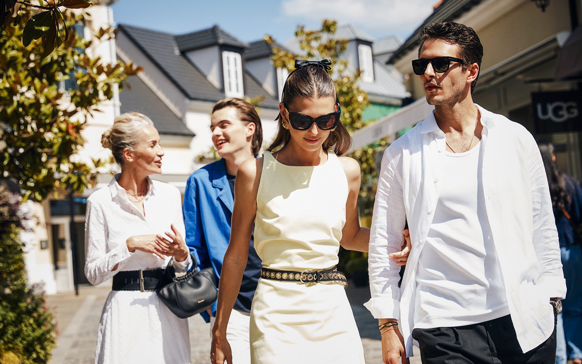 Couple walking in La Vallée Village, Paris, France, enjoying a shopping day.