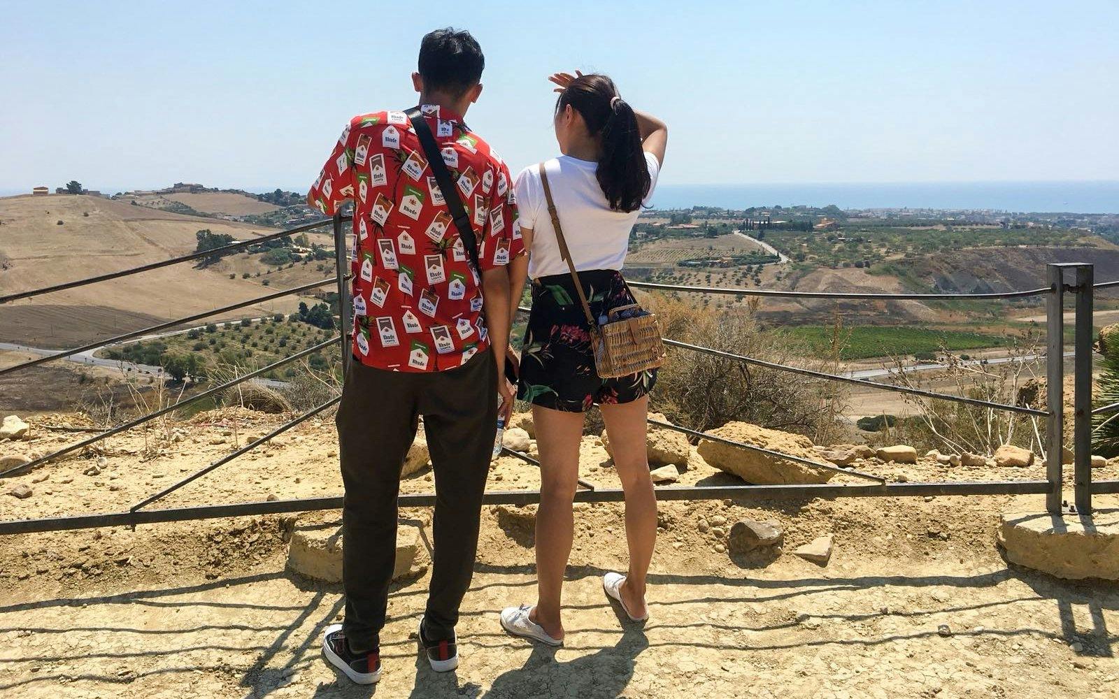 Visitors overlooking the landscape at the Valley of Temples, Italy.