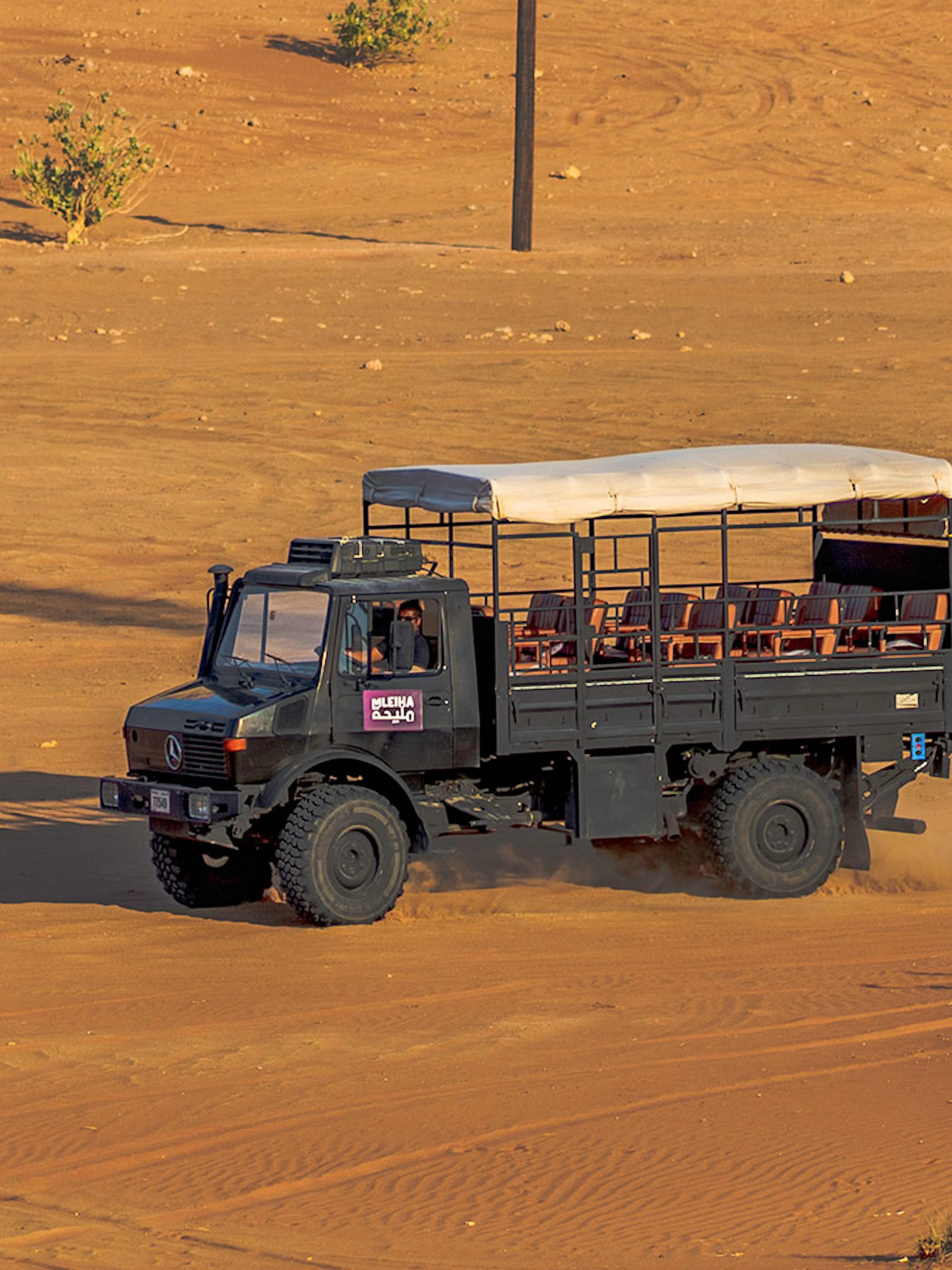 UniMog vehicle on desert terrain during Mleiha Archeological Centre guided tour in UAE.
