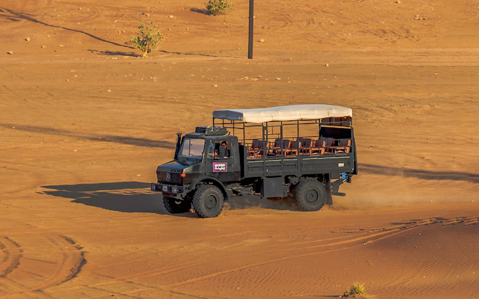 UniMog vehicle on desert terrain during Mleiha Archeological Centre guided tour in UAE.