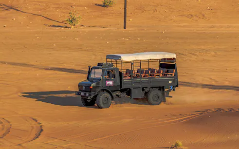UniMog vehicle on desert terrain during Mleiha Archeological Centre guided tour in UAE.