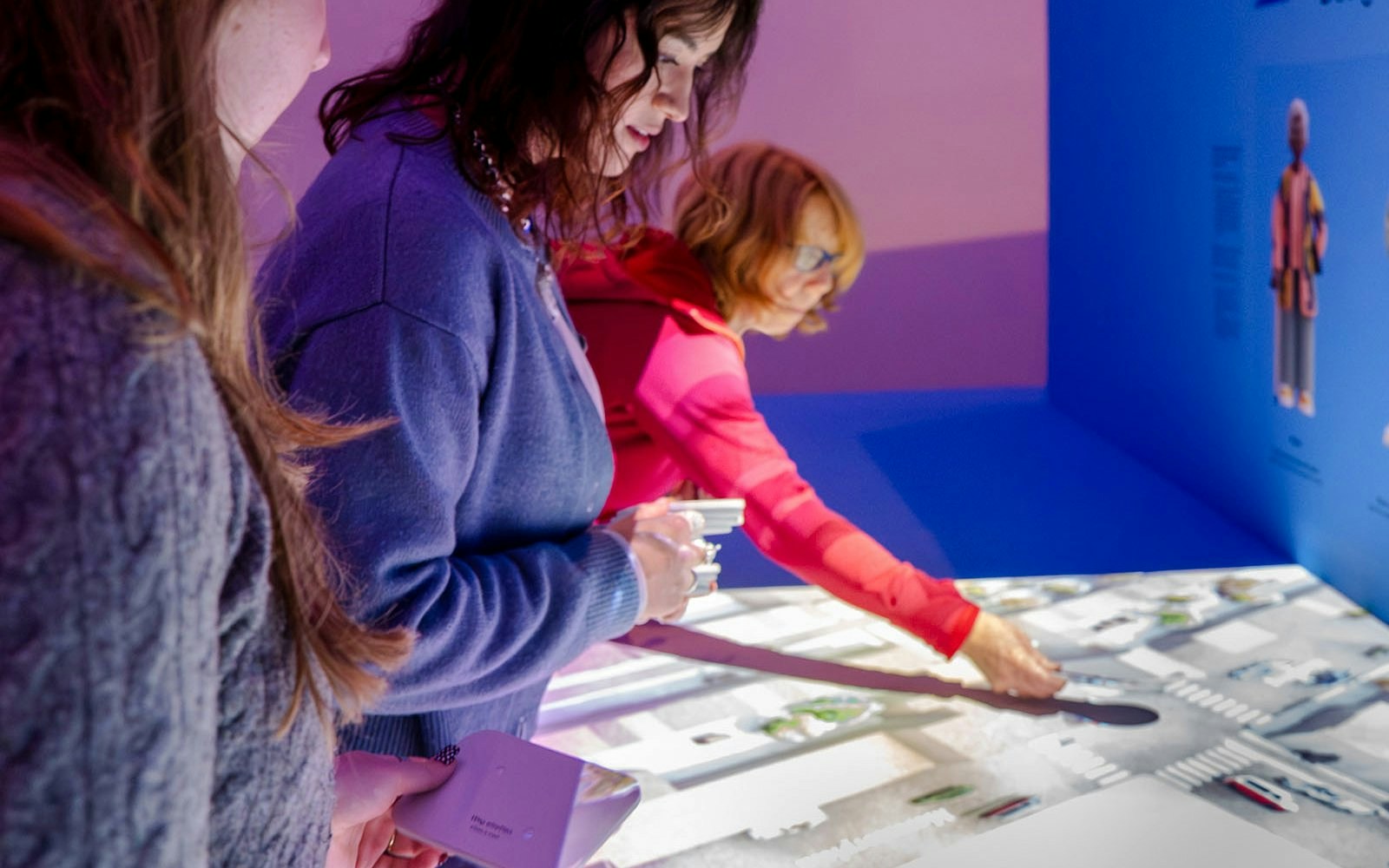 Visitors interacting with a digital map at the Amsterdam in Motion exhibit.