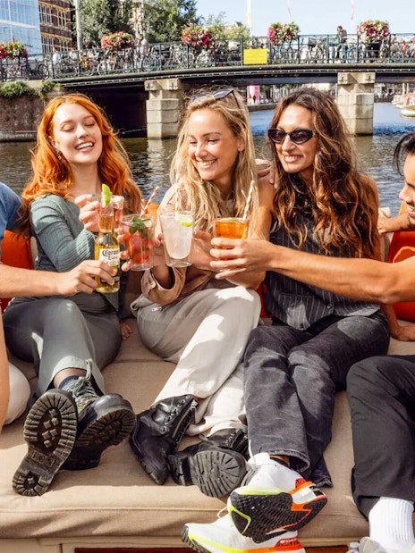 Guests enjoying drinks on the Heineken Flagship Canal Cruise in Amsterdam.