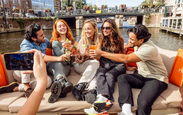 Guests enjoying drinks on the Heineken Flagship Canal Cruise in Amsterdam.