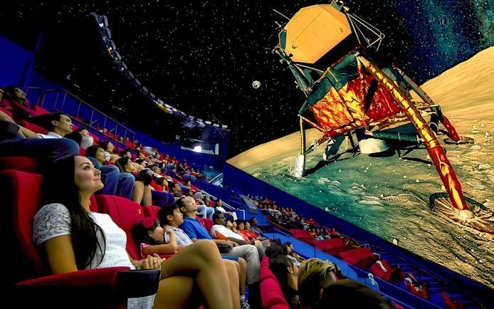 Audience watching space-themed show at Omni Theatre, Singapore.