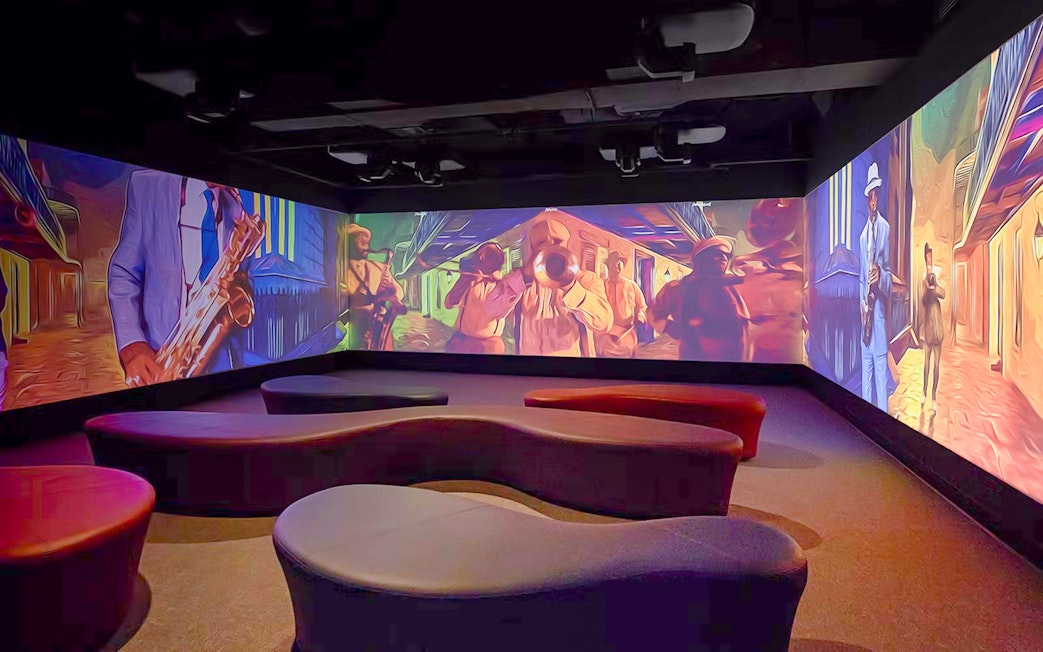 Vue Orleans Observation Deck interior with vibrant jazz-themed wall projections.