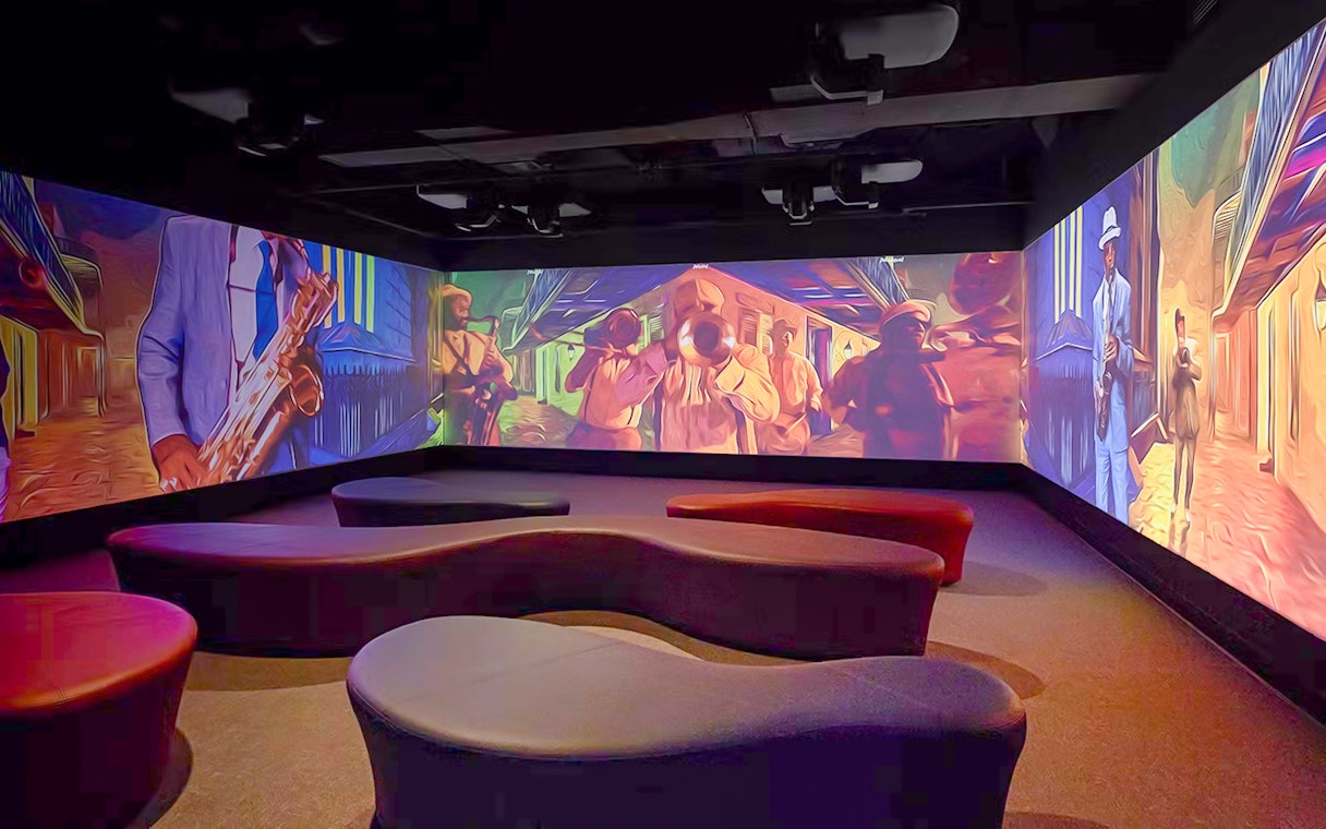 Vue Orleans Observation Deck interior with vibrant jazz-themed wall projections.
