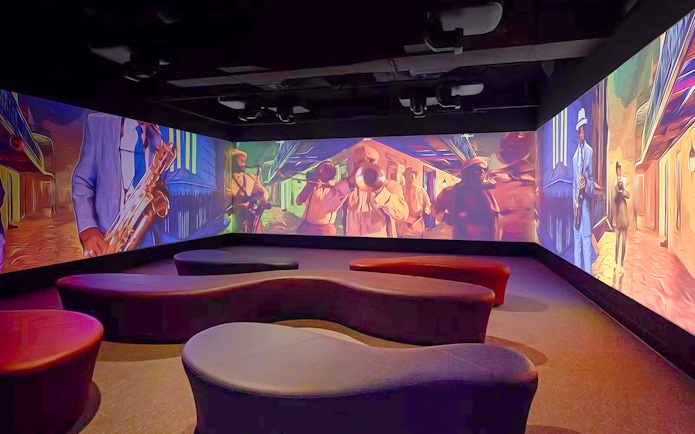 Vue Orleans Observation Deck interior with vibrant jazz-themed wall projections.