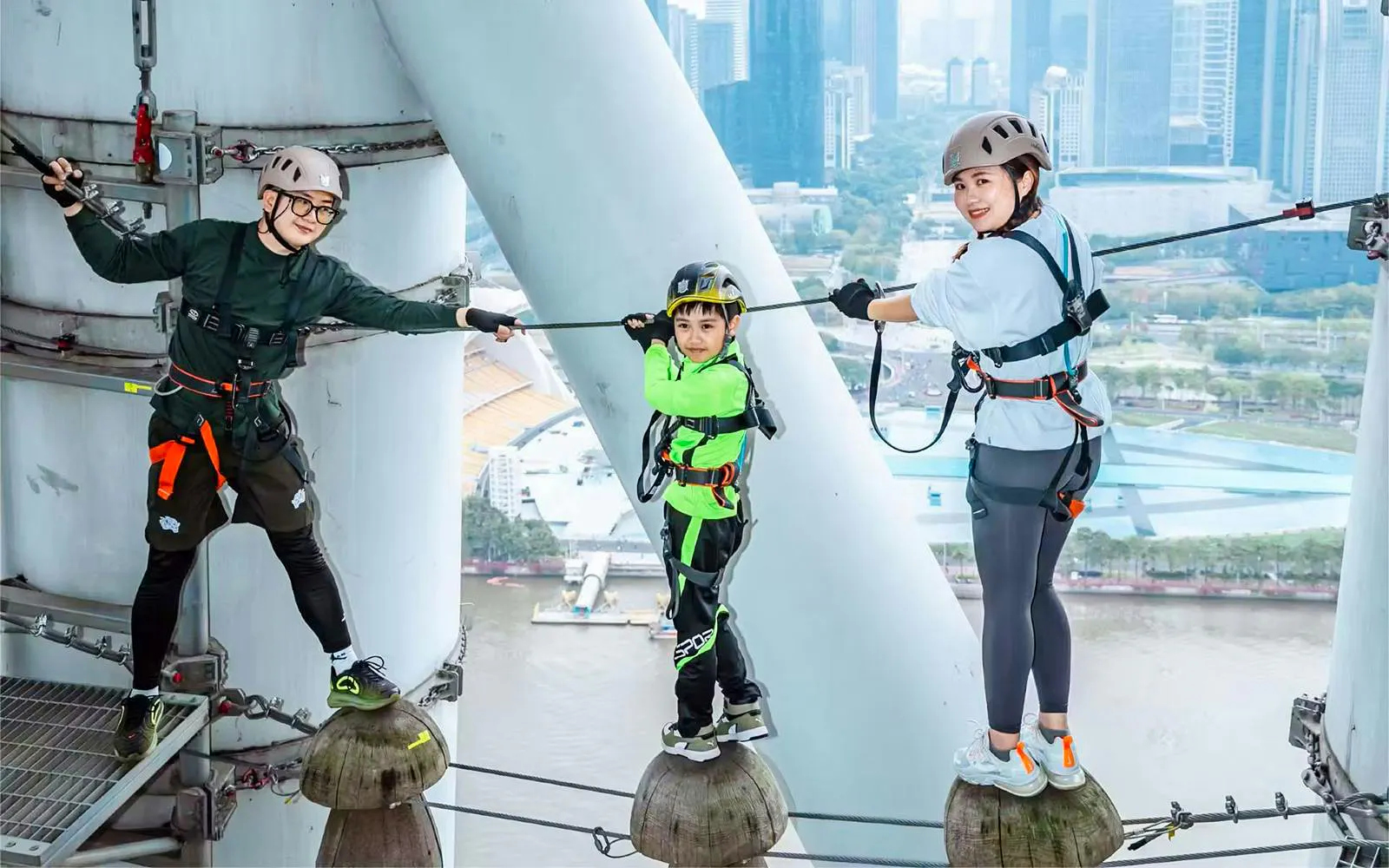 Participants on a high-altitude ropes course at Alpha Discovery Park, Canton Tower, Guangzhou.