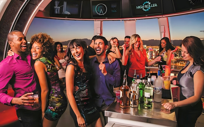 Guests enjoying drinks and city views on the High Roller Wheel, Las Vegas.