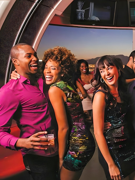 Guests enjoying drinks and city views on the High Roller Wheel, Las Vegas.
