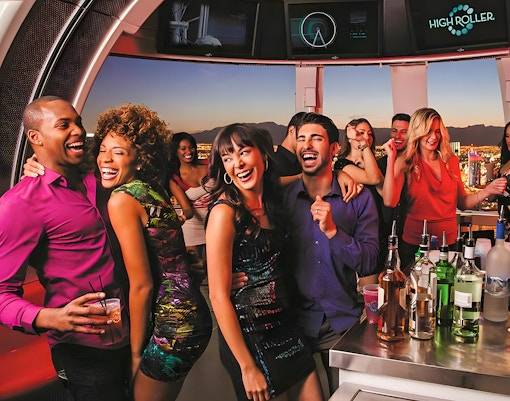 Guests enjoying drinks and city views on the High Roller Wheel, Las Vegas.