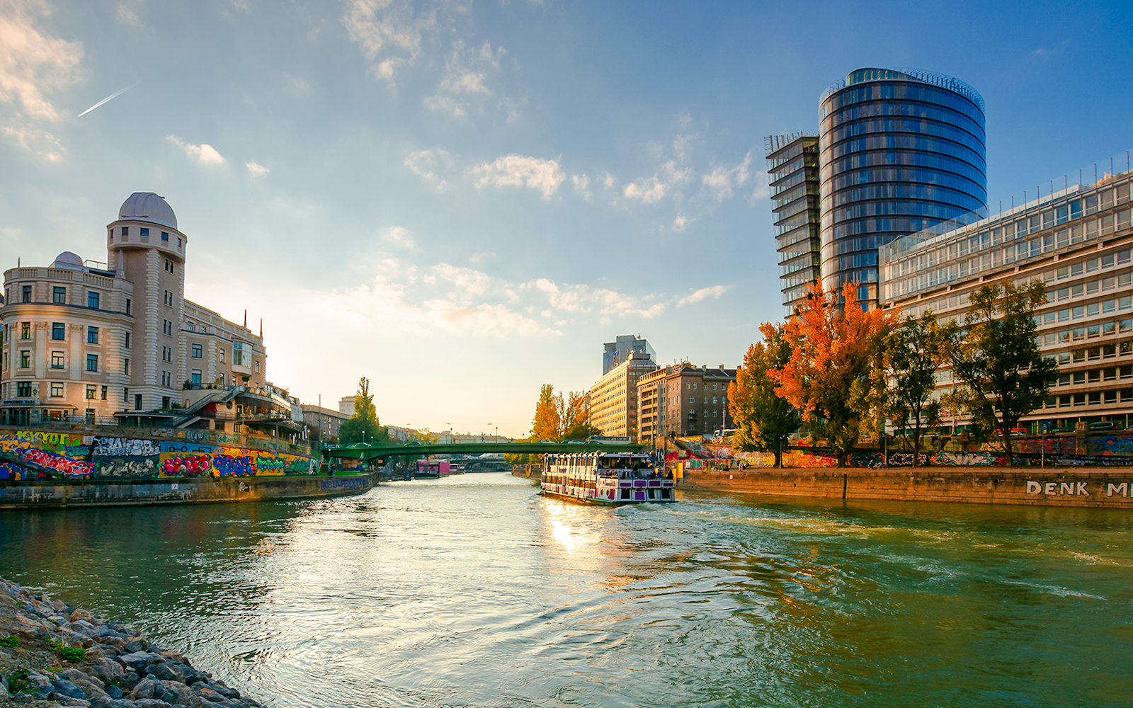 Cityscape of Vienna with Danube channel and modern buildings.