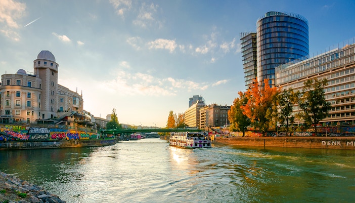 Cityscape of Vienna with Danube channel and modern buildings.