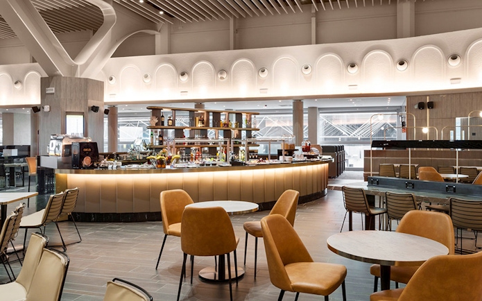 Premium lounge interior at Leonardo da Vinci-Fiumicino Airport with seating and bar area.