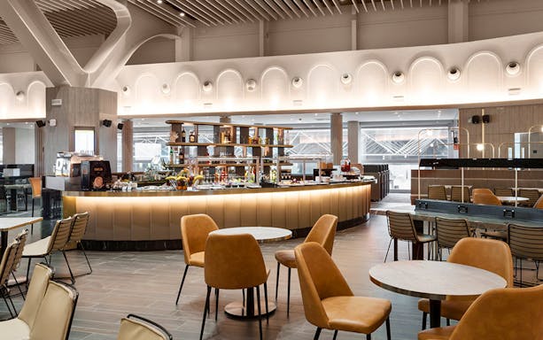 Premium lounge interior at Leonardo da Vinci-Fiumicino Airport with seating and bar area.
