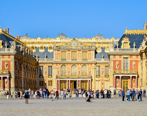 Versailles Palace front entry with ornate architecture in Les Yvelines, France.