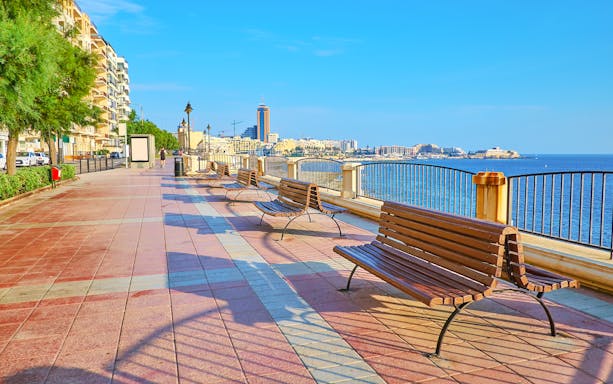 Sliema Promenade view with people walking along the waterfront in Malta.
