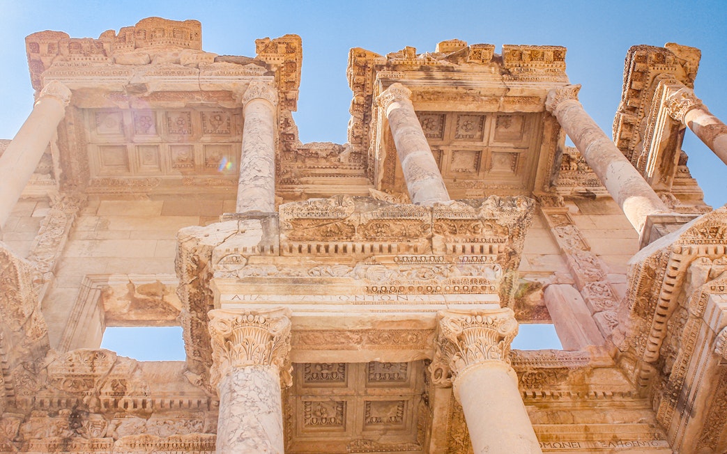 Ancient Library of Celsus in Ephesus, Turkey, viewed from below on a sunny day.