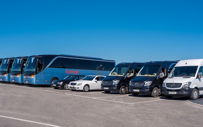 Tour buses and vans for Akrotiri Excavations and Red Beach transfers.