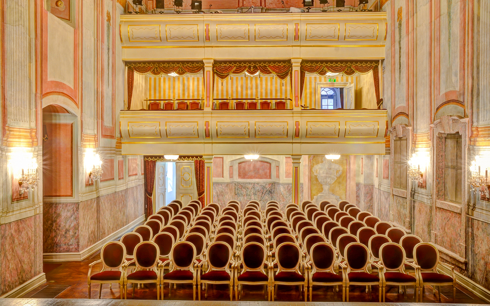 Interior seating and balconies of the Royal Palace of Gödöllő theater hall.
