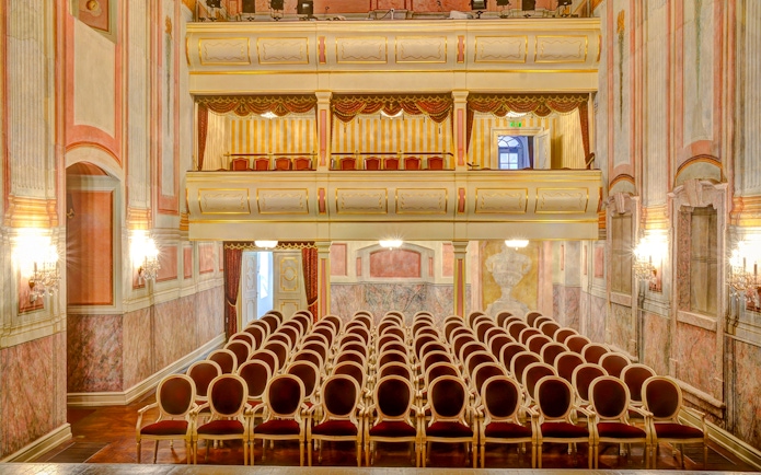 Interior seating and balconies of the Royal Palace of Gödöllő theater hall.