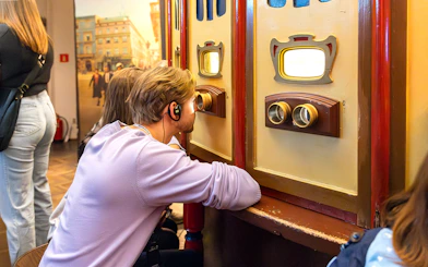 Visitor using audio guide at Oskar Schindler's Factory exhibit in Krakow, Poland.