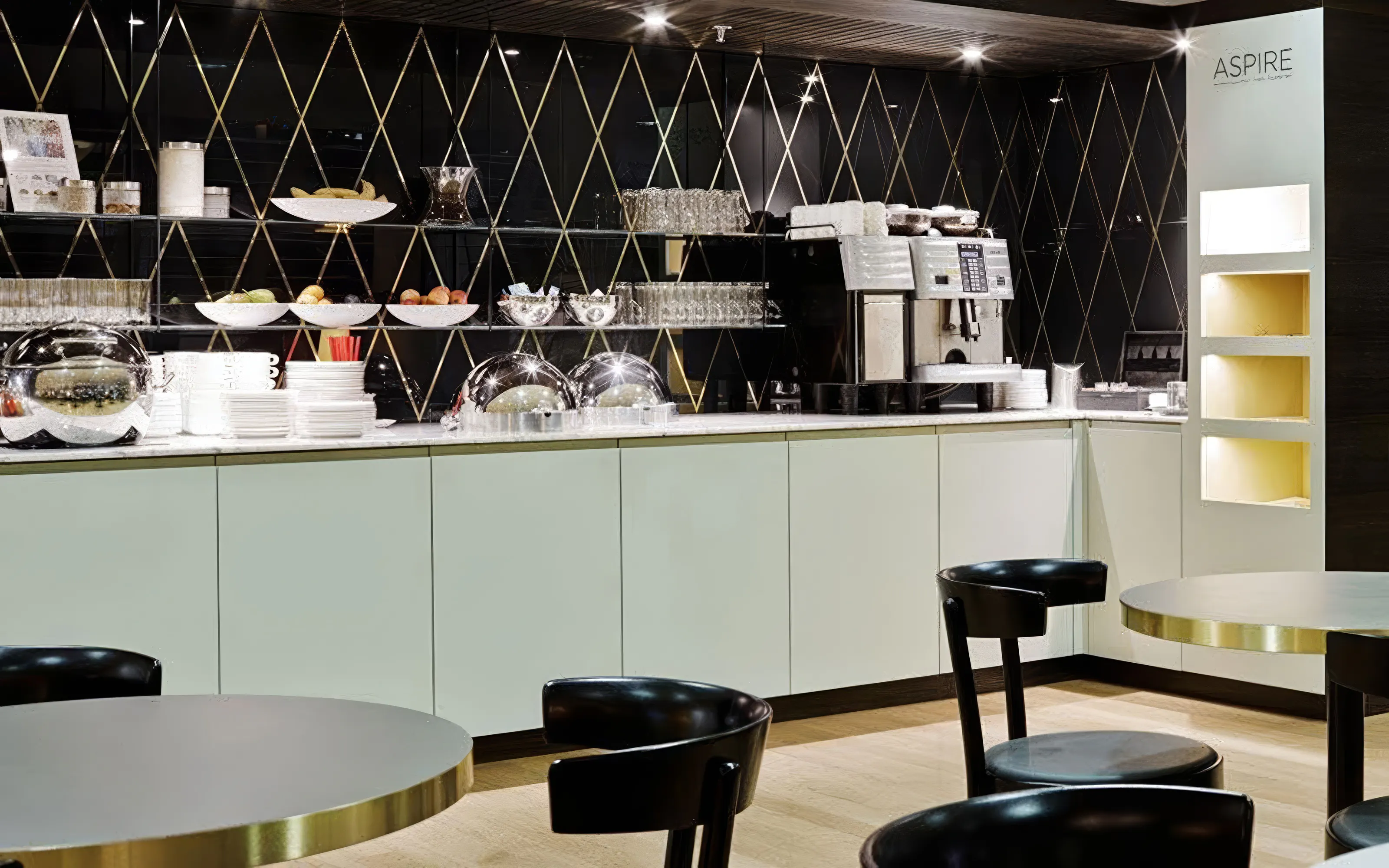Aspire ONE Lounge Zurich Airport buffet area with coffee machine and seating.