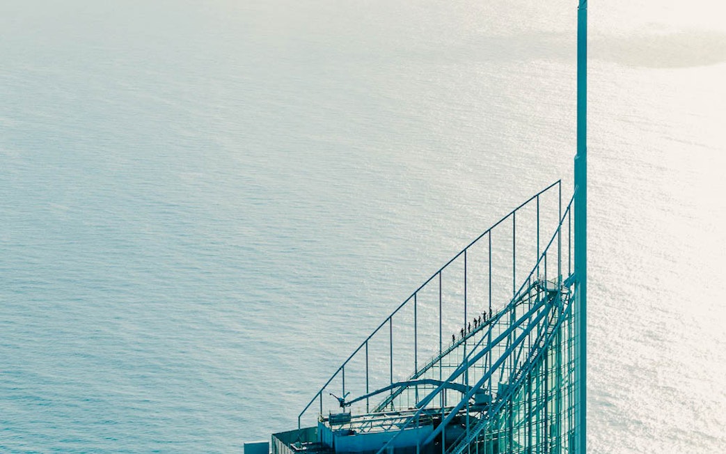 Climbers on SkyPoint observation deck overlooking ocean, Gold Coast, Australia.