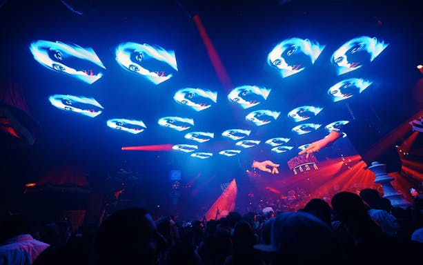 Crowd enjoying Bedouin Saga at Pacha Ibiza with vibrant light show.