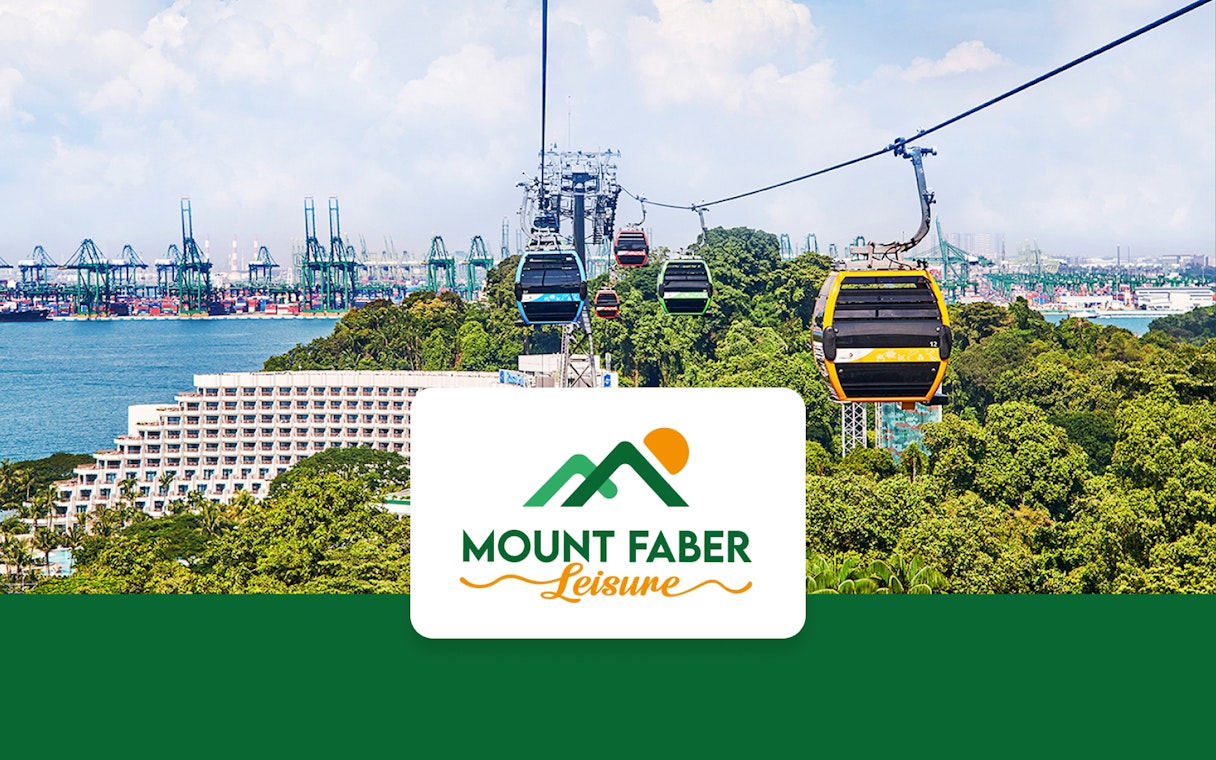 Singapore Cable Car over lush greenery with city skyline in the background.