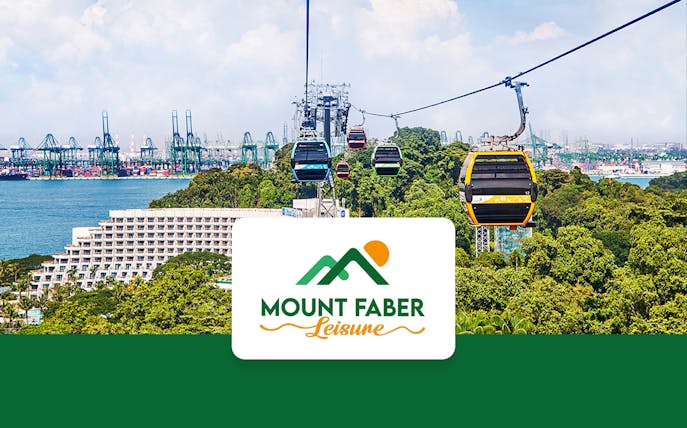 Singapore Cable Car over lush greenery with city skyline in the background.