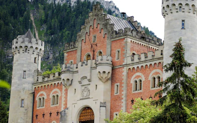 Entrance of Neuschwanstein Castle with towers and ornate facade in Bavaria, Germany.