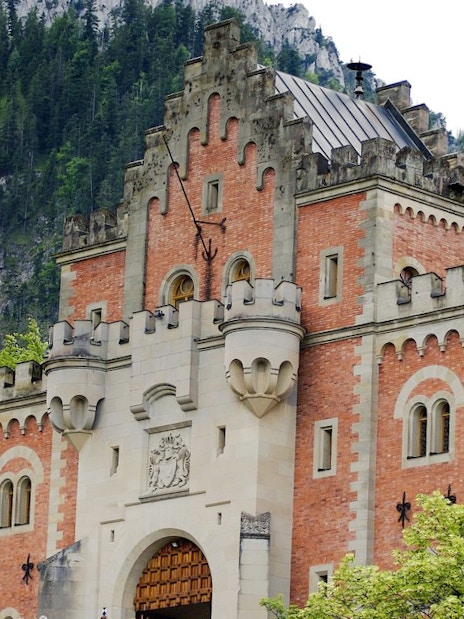 Entrance of Neuschwanstein Castle with towers and ornate facade in Bavaria, Germany.