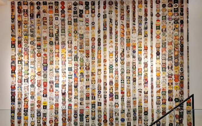 Beer label collection display inside Prague Beer Museum.