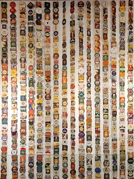 Beer label collection display inside Prague Beer Museum.