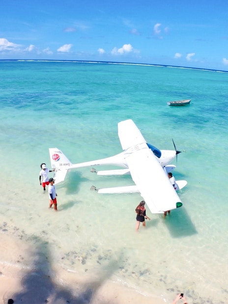 Seaplane on turquoise water near beach, Short Amber Route Scenic Tour, Mauritius.