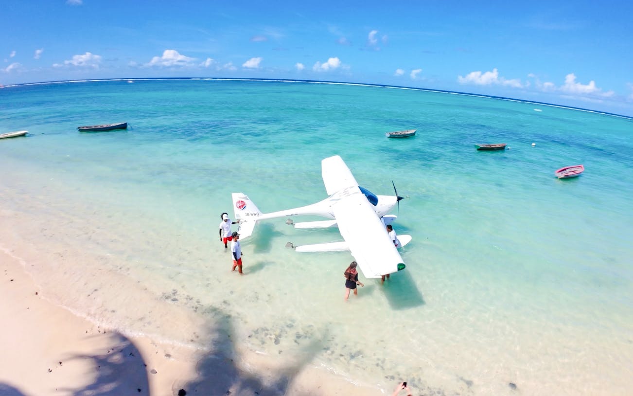 Seaplane on turquoise water near beach, Short Amber Route Scenic Tour, Mauritius.
