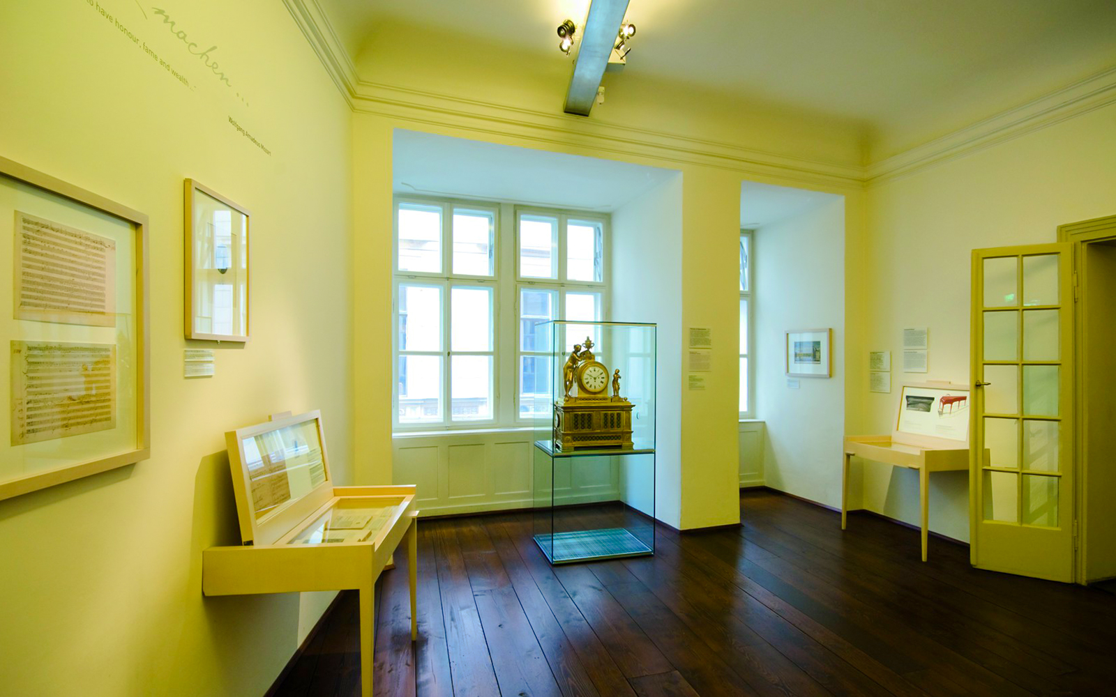Mozart's apartment interior at Mozarthaus Vienna, featuring historical exhibits and a clock display.