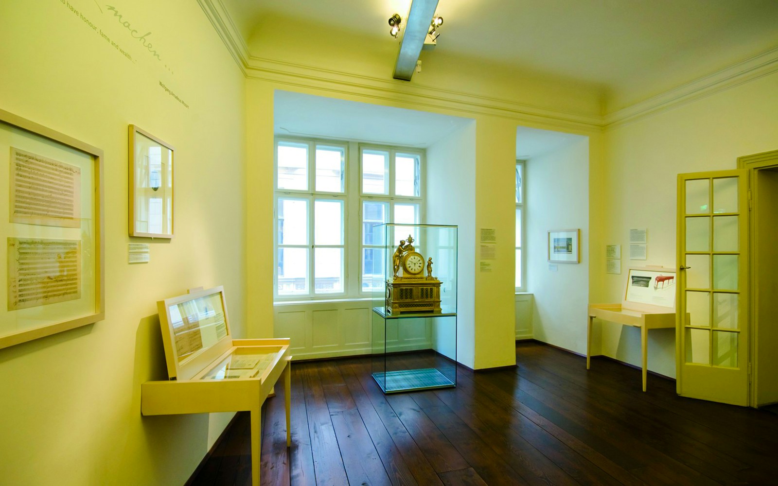 Mozart's apartment interior at Mozarthaus Vienna, featuring historical exhibits and a clock display.