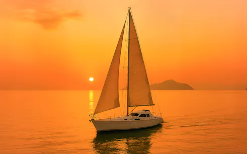 Monohull sailing at sunset in Langkawi waters.