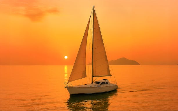 Monohull sailing at sunset in Langkawi waters.