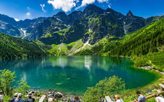Mountain lake view in Zakopane with tourists, part of Krakow day tour including Gubałówka cable car.