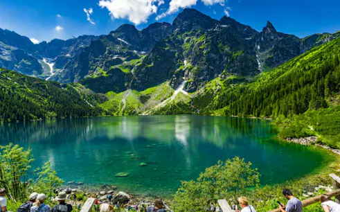 Mountain lake view in Zakopane with tourists, part of Krakow day tour including Gubałówka cable car.