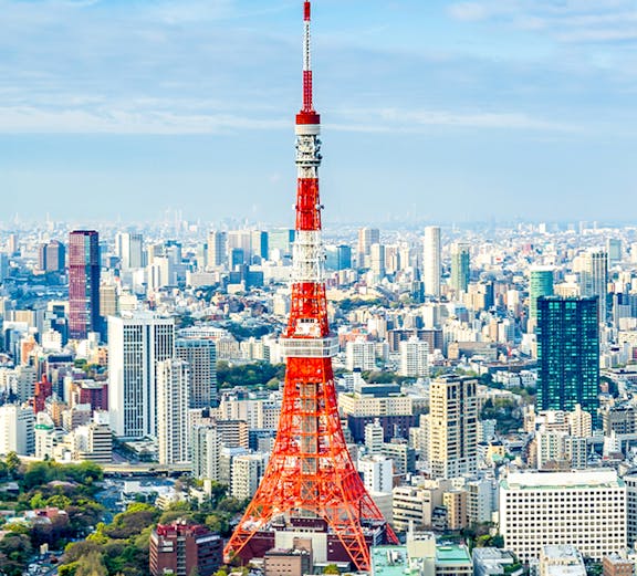 Tokyo Tower rising above the city skyline in Tokyo, Japan.