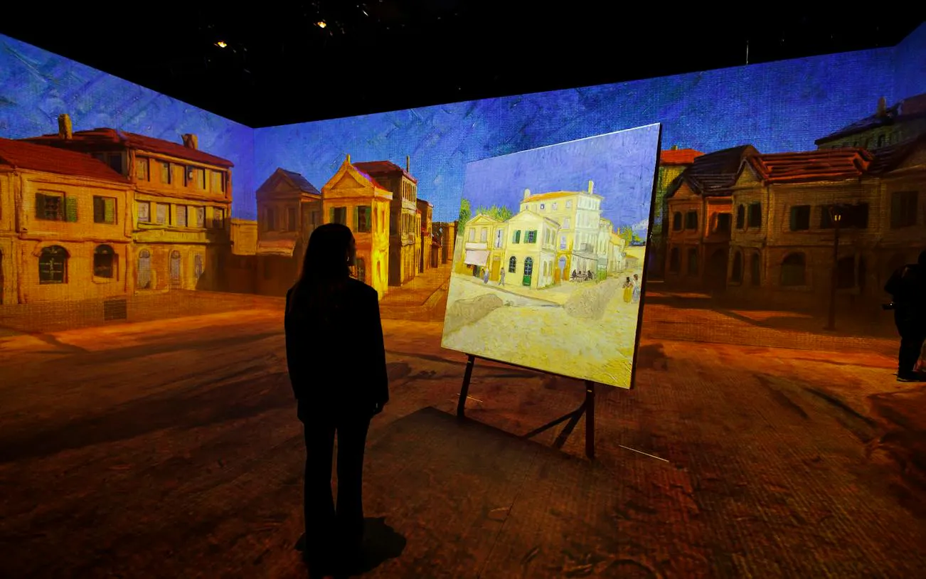 Visitor viewing Van Gogh immersive exhibit in Zurich, featuring projected artwork and cityscape.