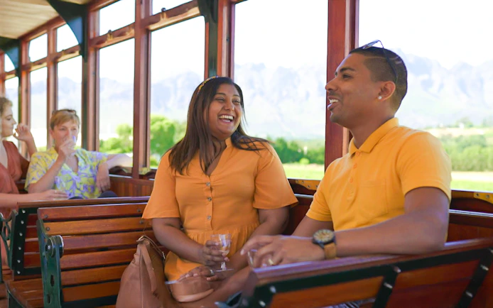 Couple enjoying Franschhoek Wine Tram Xplorer Tour, Cape Town.