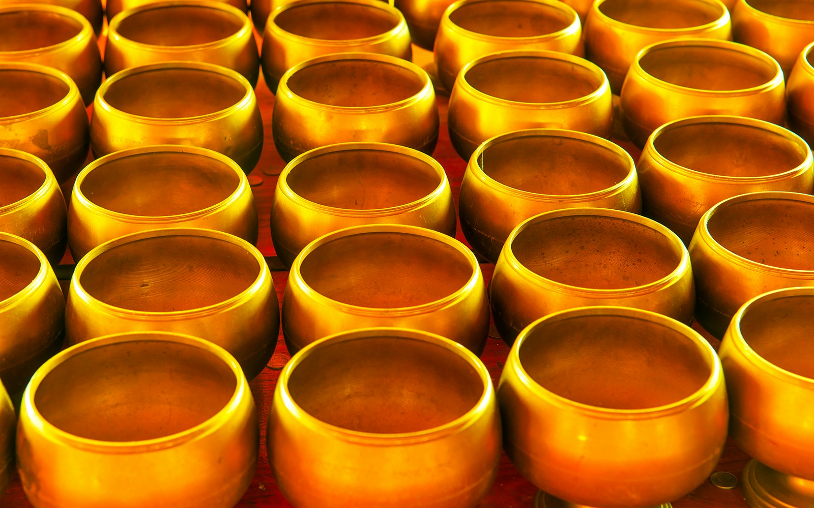 Bronze alm bowls displayed at Baan Bu Bronzework Community.